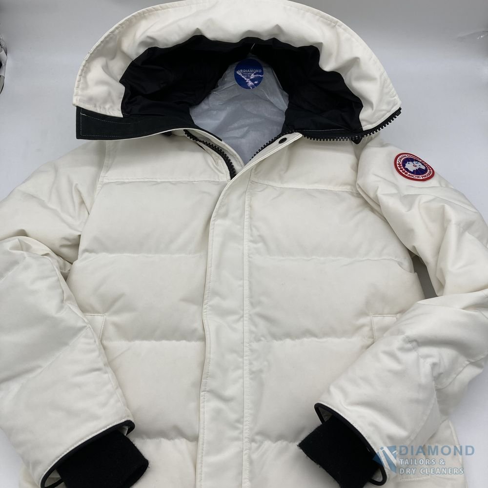 The same Canada Goose parka after cleaning — the white fabric returned to an even, bright finish