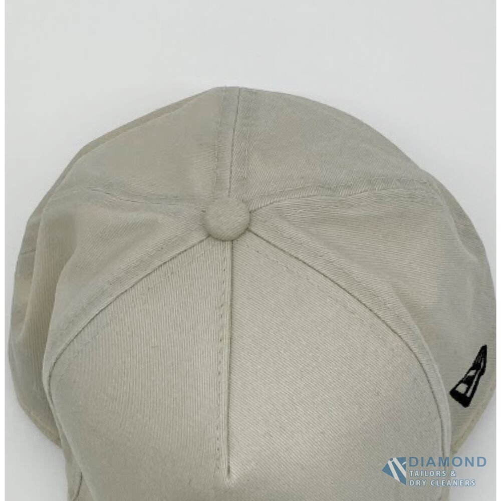 The same cap after cleaning — the crown returned to an even cream with no trace of the stain