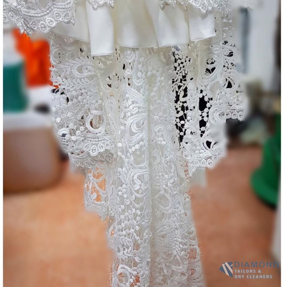 The same lace hem after cleaning — brightened to a clean, even white